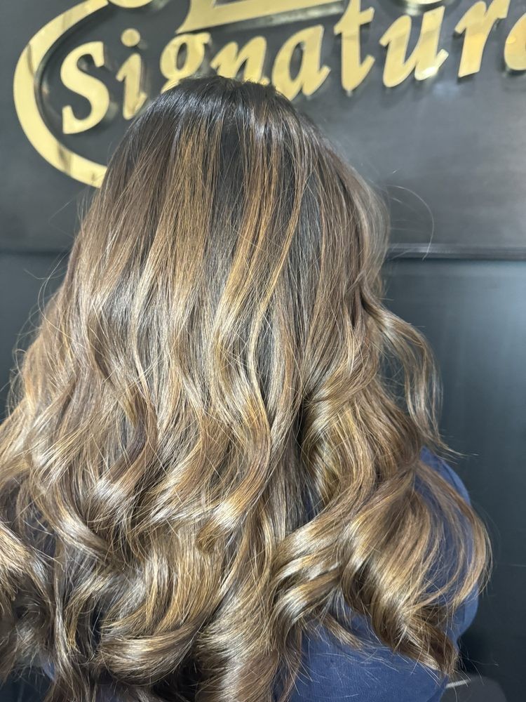 Honey-blonde balayage with glossy barrel curls