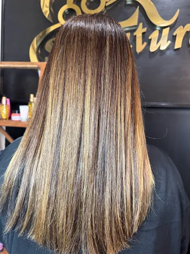 Sleek long hair with honey and golden highlights